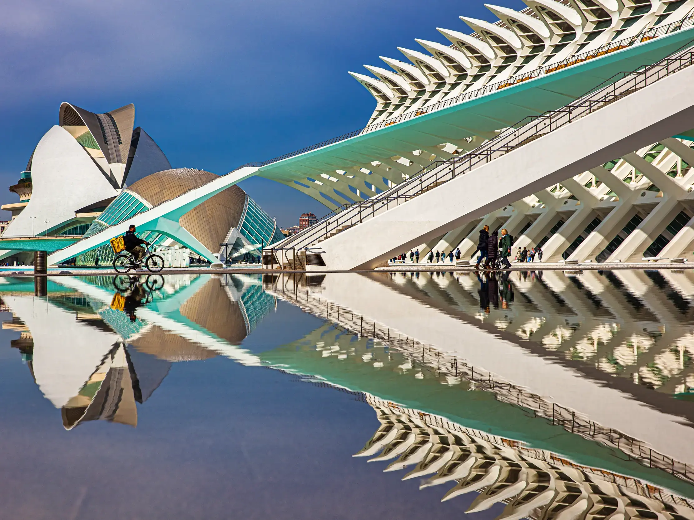 Die futuristische Architektur von Santiago Calatravas Ciutat de les Arts i les Ciències in Valencia spiegelt sich im Wasser.