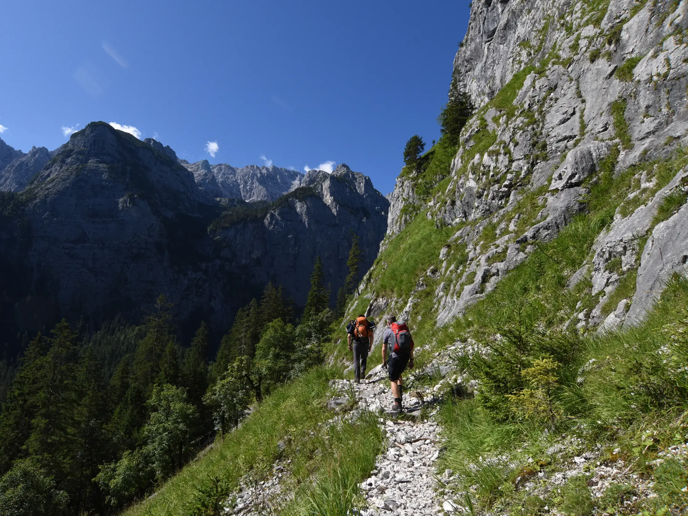 Zwei Bergsteiger auf dem schmalen Felsensteig während der anspruchsvollen Wanderung durch das Reintal zur Zugspitze.