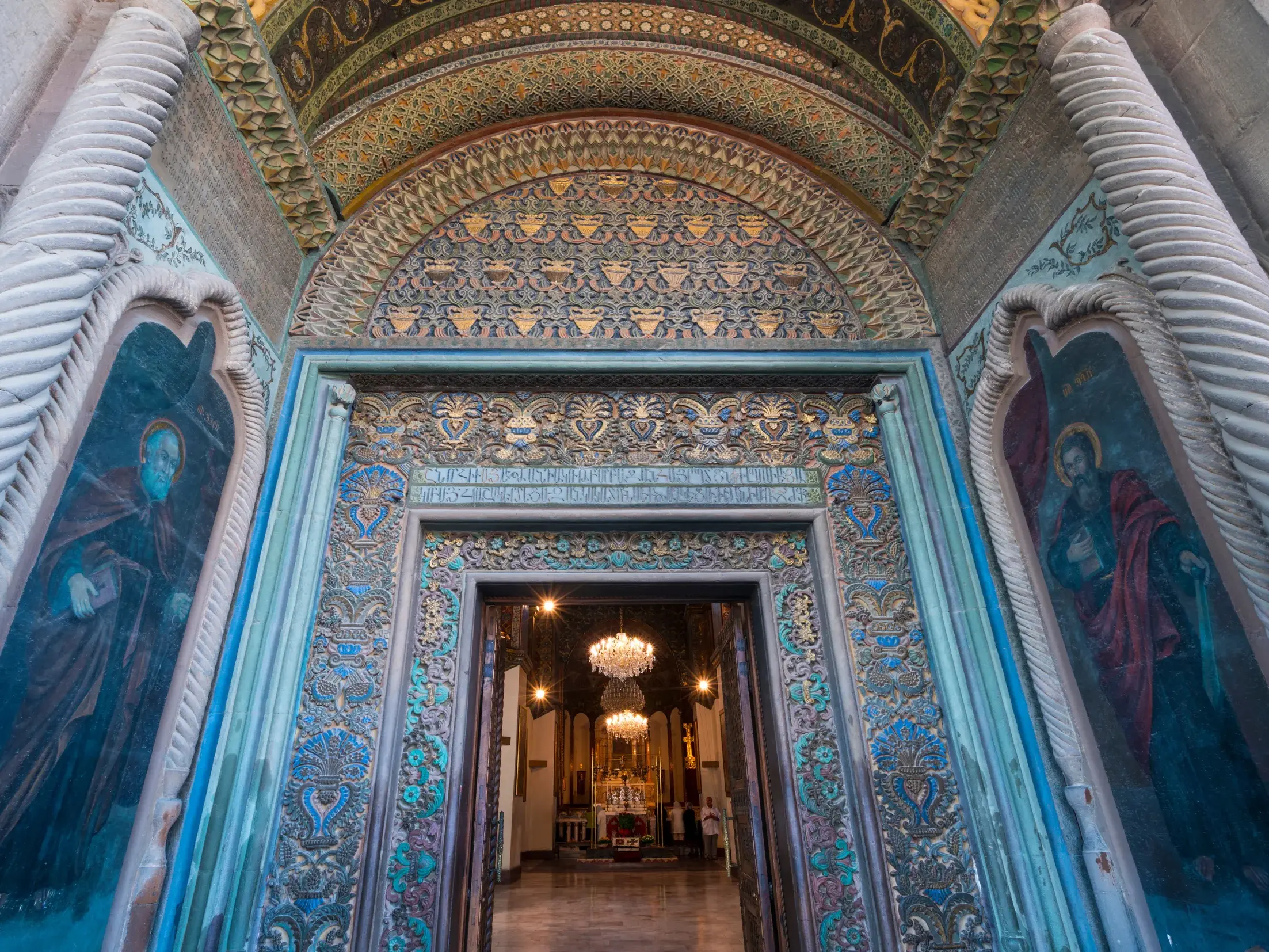 Reich verziertes Eingangsportal der Kathedrale von Etschmiadsin in Armenien mit kunstvollen Reliefs und gedrehten Säulen.