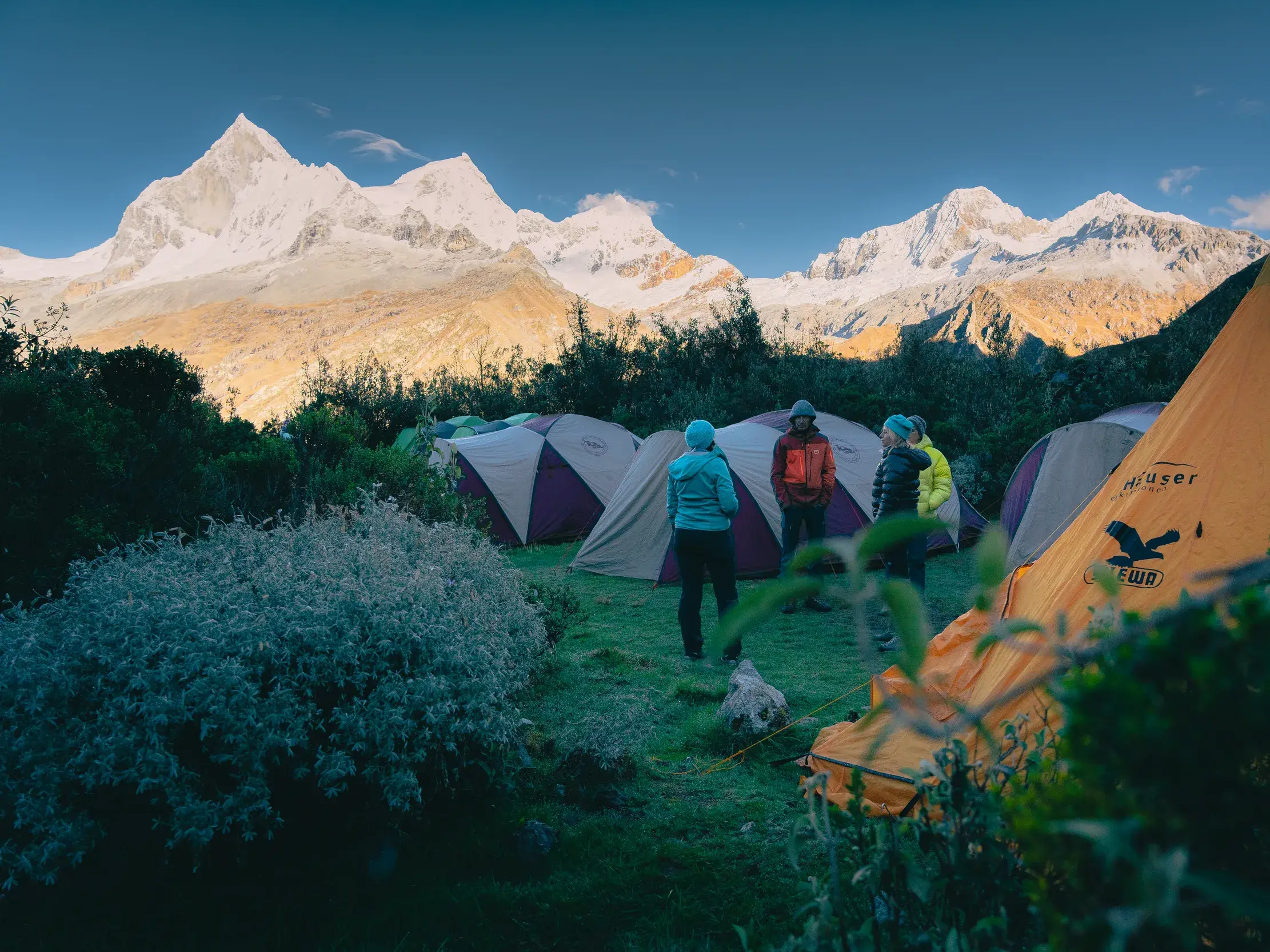 Eine Hauser-Reisegruppe vor ihren Luxuszelten auf einem Zeltplatz in der Bergwelt der peruanischen Cordillera Blanca.