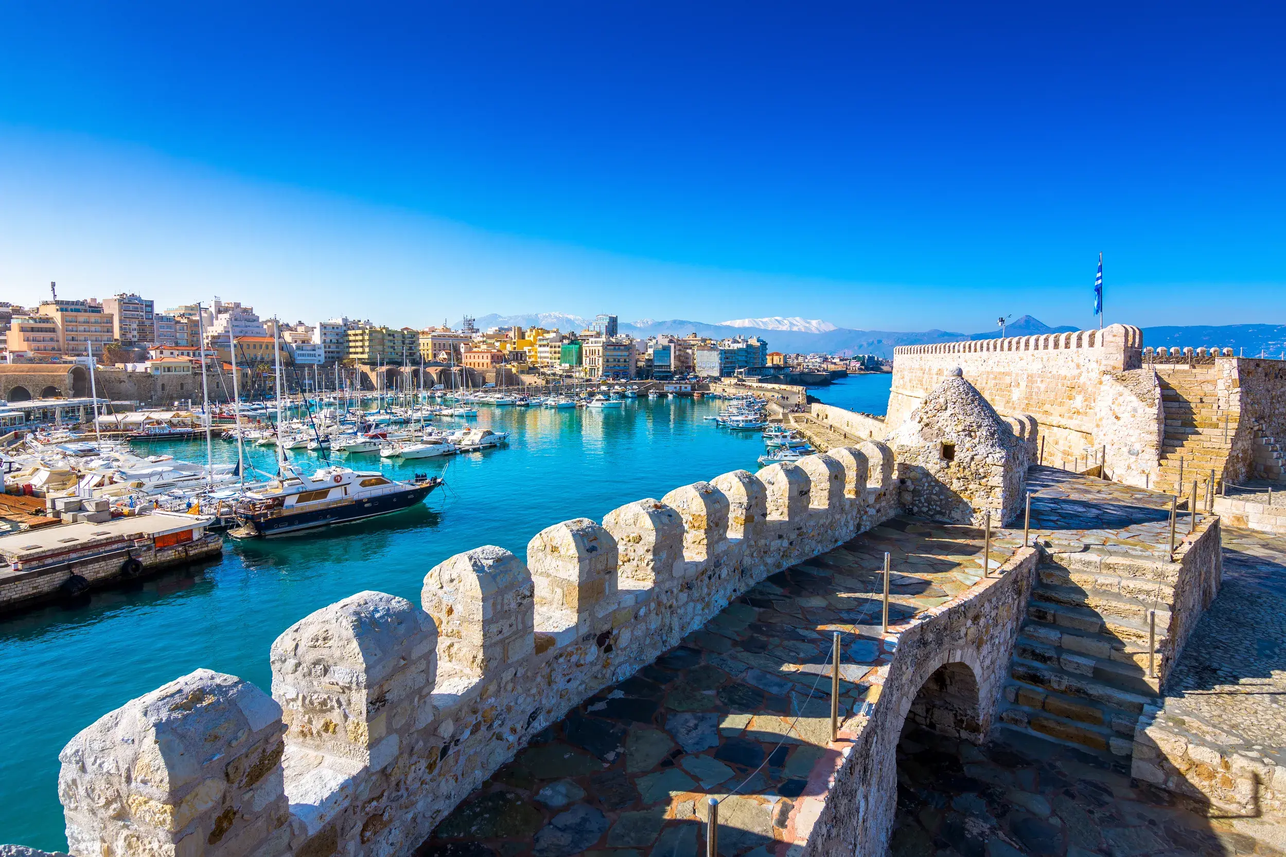 Blick von der historischen Koules-Festung auf den venezianischen Hafen von Heraklion auf Kreta bei strahlend blauem Himmel.