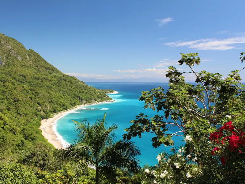 Panoramablick auf die Küstenstraße im Nationalpark Jaragua mit Traumstrand, türkisfarbenem Meer und üppiger Vegetation.