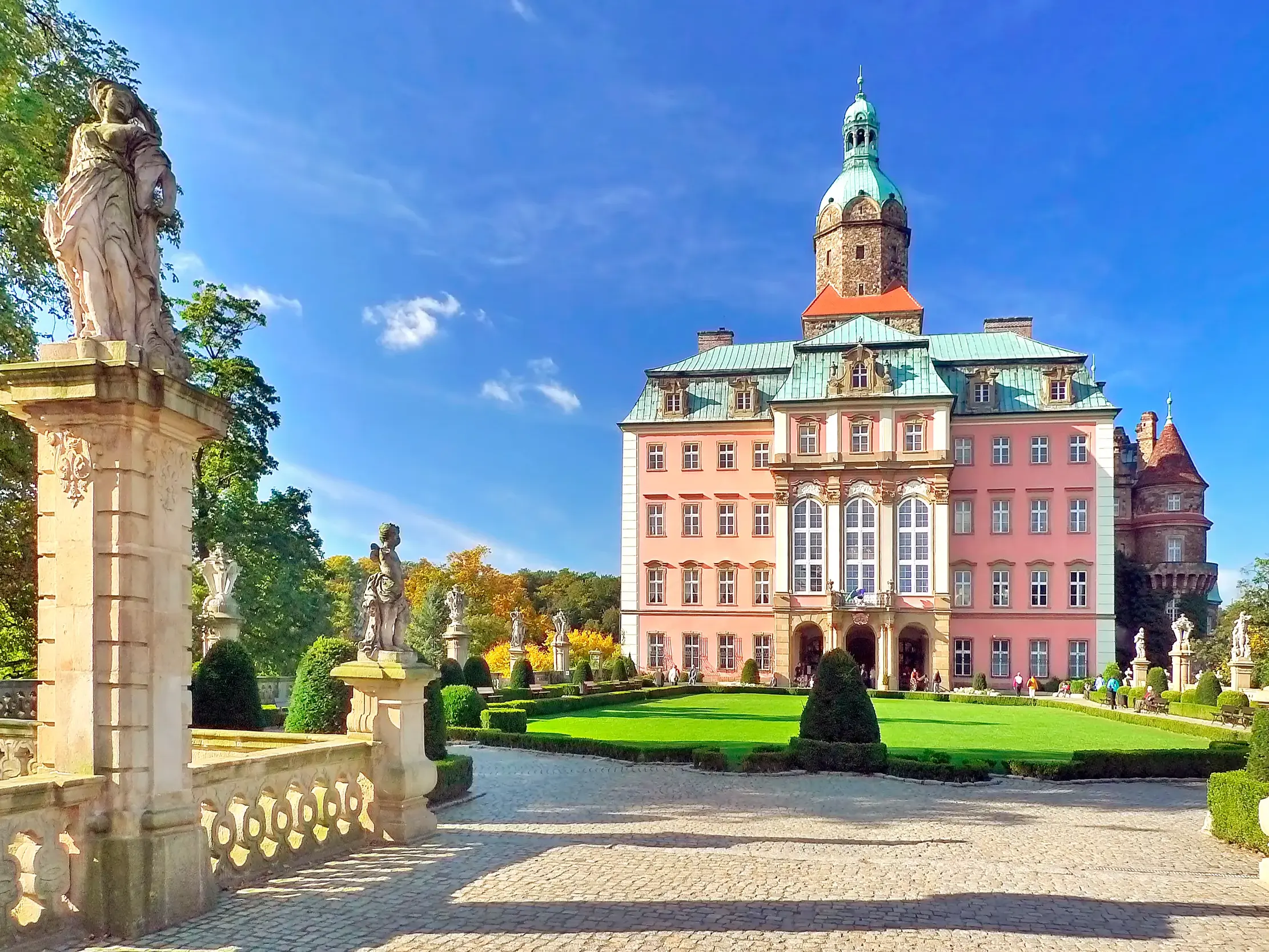 Schloss Fürstenstein (Książ) bei Walbrzych mit barocker Fassade, Schlossturm und gepflegtem Garten.