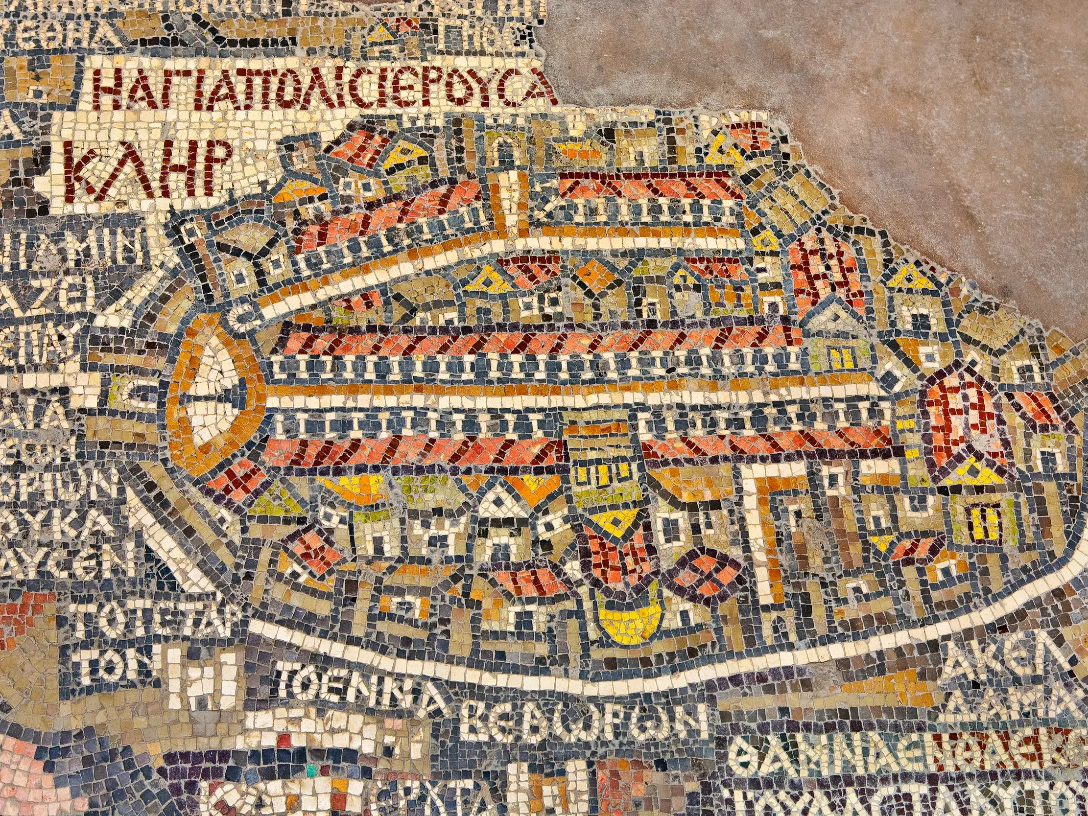 Nahaufnahme der antiken Mosaikkarte von Madaba, die detailreich die heilige Stadt Jerusalem mit griechischer Schrift zeigt.