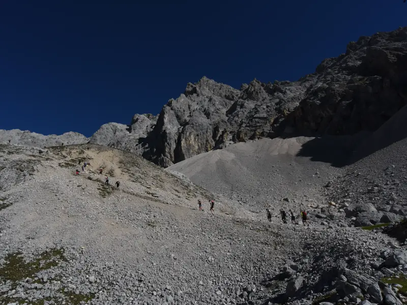 Eine Hauser-Wandergruppe auf dem anspruchsvollen Aufstieg über geröllreiche Moränen zum Gipfel der Zugspitze in den Alpen.