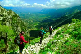 Eine Hauser-Wandergruppe auf einem felsigen Pfad mit Panoramablick über das Shushica-Tal im albanischen Küstengebirge.