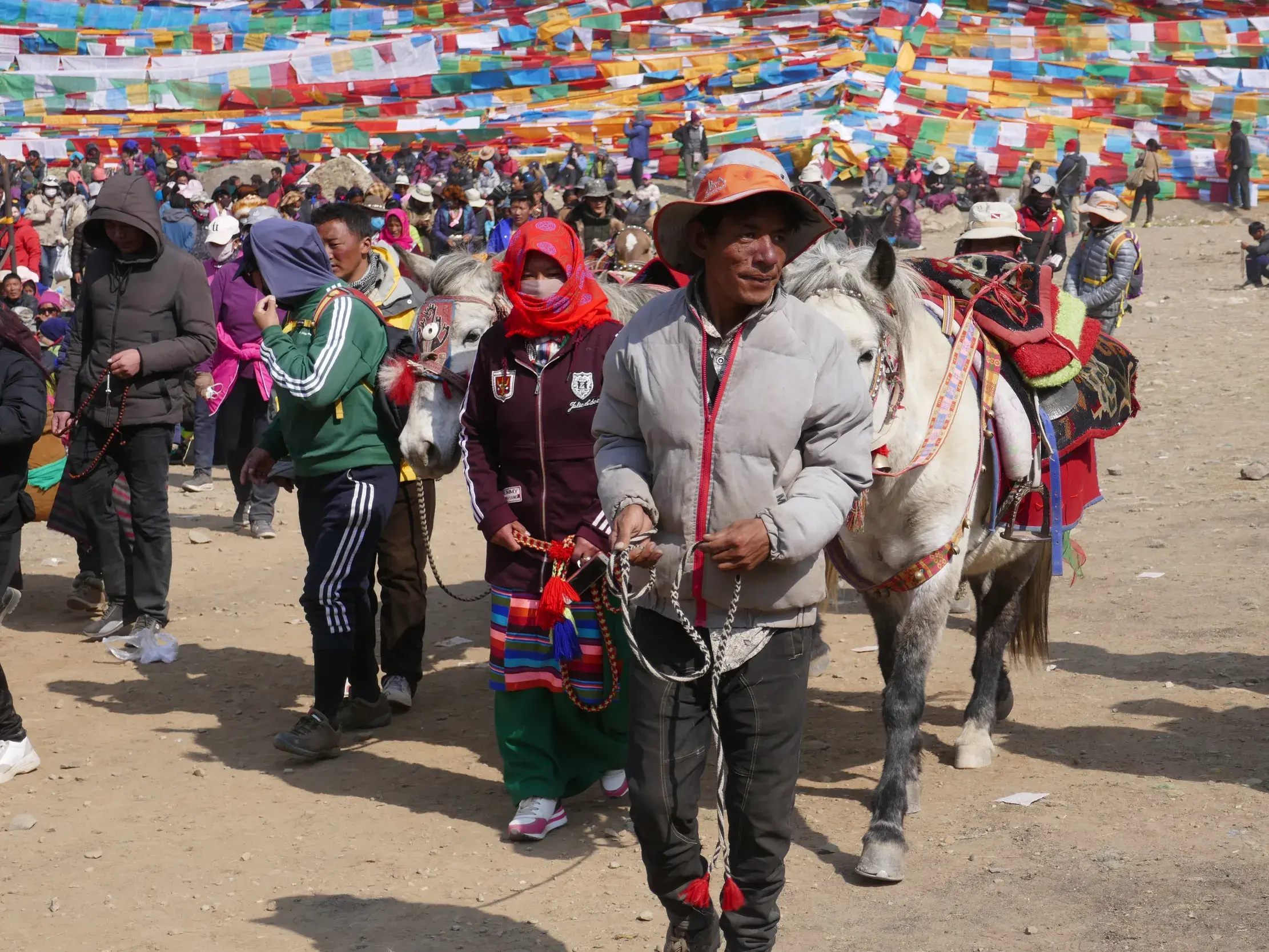 Tibetische Pilger mit einem bepackten Pferd auf der Trekking-Route zur Umrundung des heiligen Berges Kailash in Tibet.