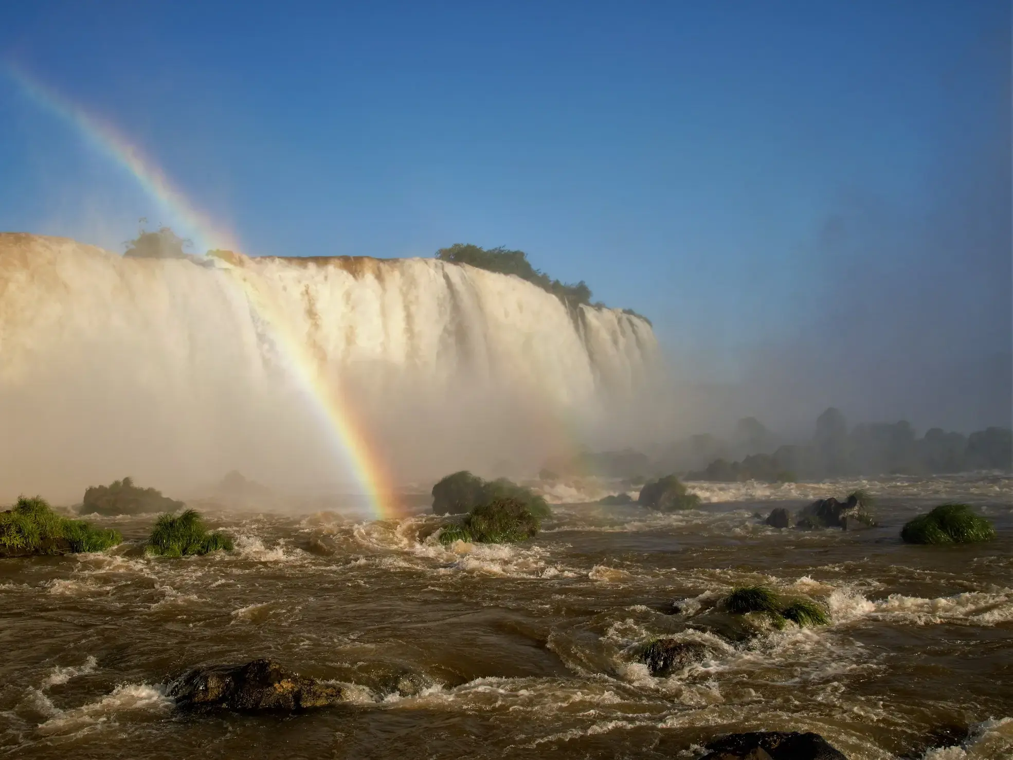 Gewaltige Wassermassen stürzen in Brasilien in die Tiefe und ein Regenbogen spannt sich über den Sprühnebel in der Chapada Diamantina.