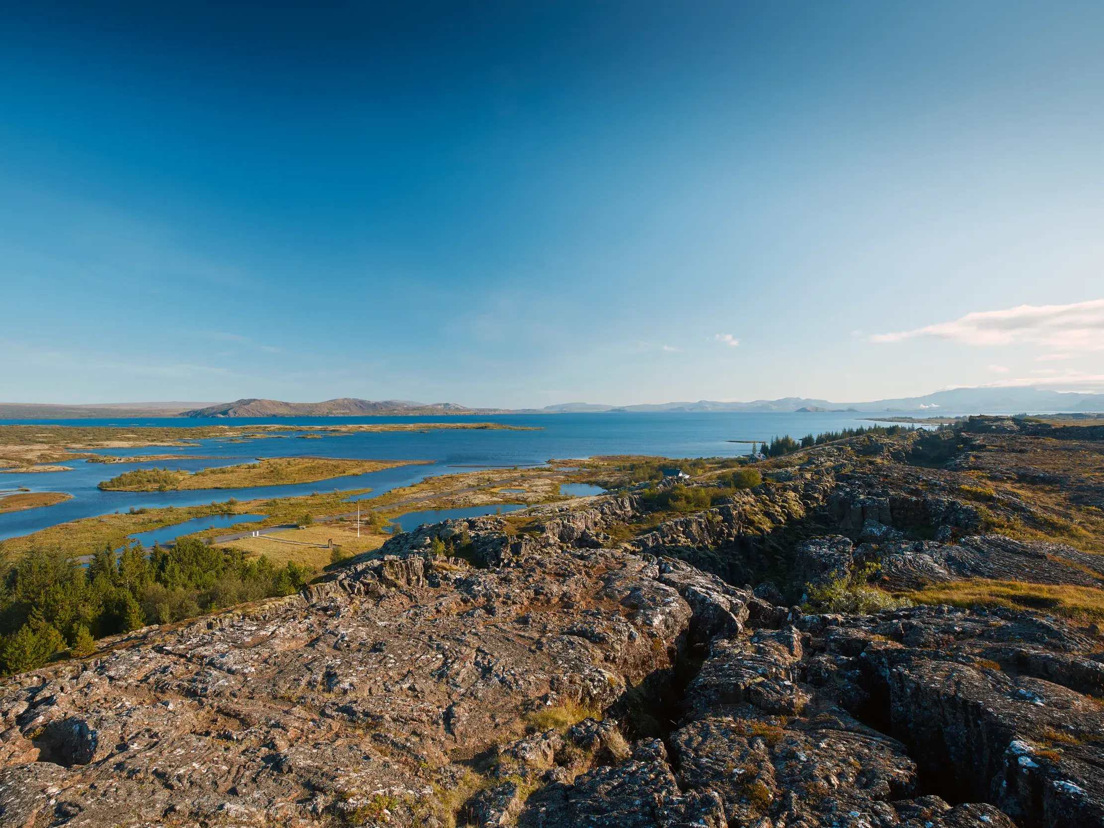 Blick von der Felskante der Kontinentalplatten über die weite Seenlandschaft im Thingvellir Nationalpark am Goldenen Ring in Island.