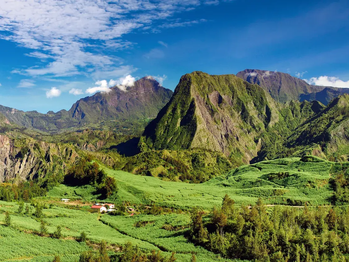 Panoramablick auf die üppig grünen, vulkanischen Berge und Felder im Talkessel Salazie auf der Insel La Réunion.