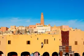 Die einzigartige Wüstenarchitektur der Oasenstadt Ghardaia (UNESCO-Welterbe) mit Minarett und buntem Markttreiben.