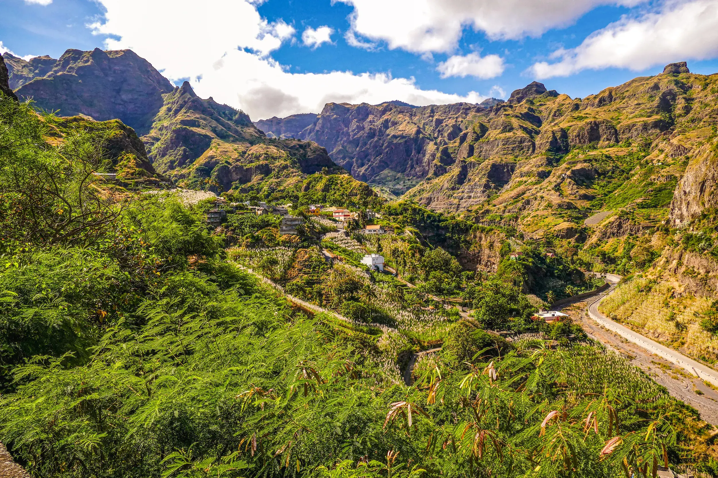 Weitblick beim Wandern über das grüne Paul-Tal auf Santo Antão mit üppiger Vegetation und schroffer Bergkette am Horizont.