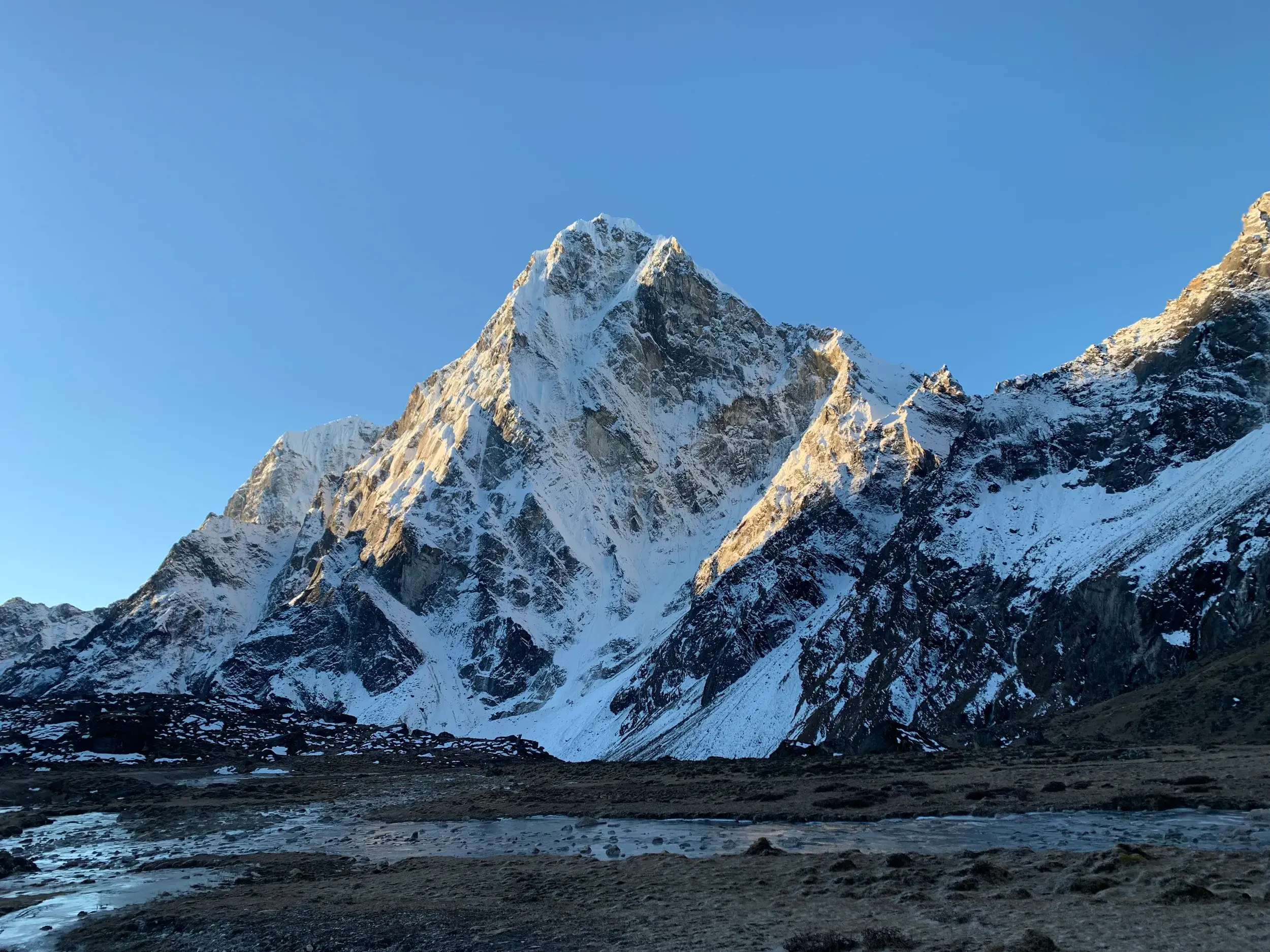 Der markante, schneebedeckte Gipfel der Ama Dablam im Himalaya bei Sonnenaufgang während einer Trekkingreise in Nepal.