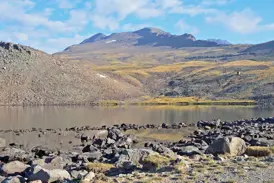 Der stille Kari-See auf 3.200 Metern Höhe vor dem Panorama des Aragats-Massivs in der Hochgebirgslandschaft Armeniens.